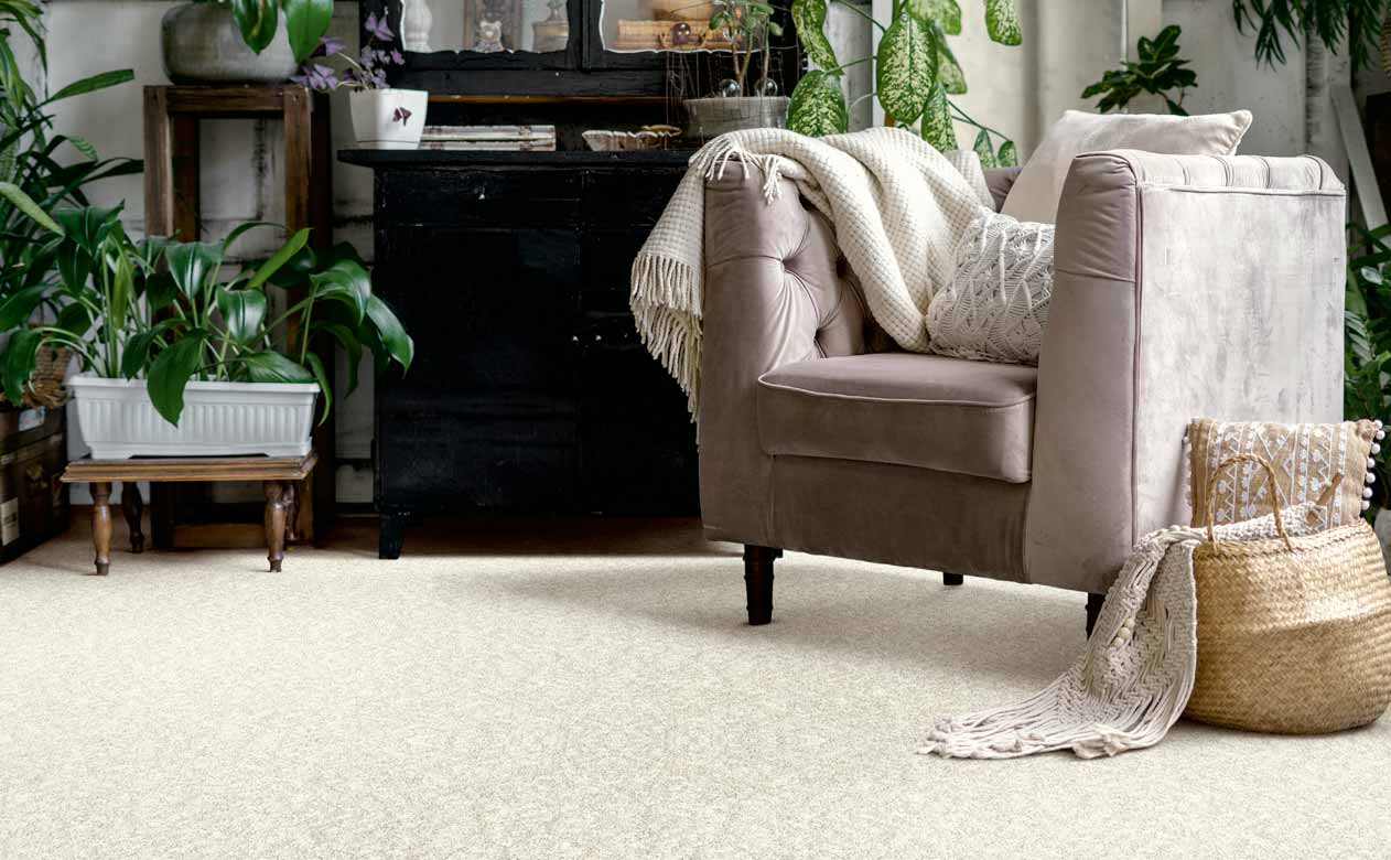 Living room with brown chair, and dresser with beige carpet