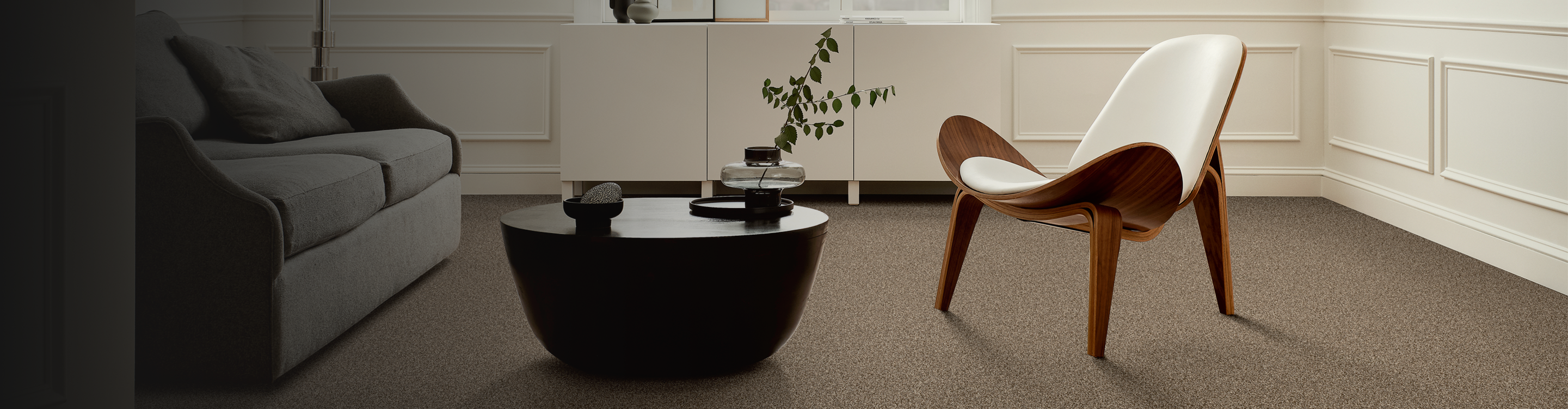 Living room with modern accent chair and brown carpet